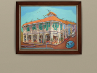 Heritage painting of Blair Road shophouses shown framed on a gallery wall.