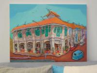 Original Singapore heritage painting Blair Road Corner shown on a sofa for size reference