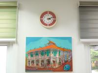 18x24 inch shophouse architectural art Blair Road Corner hung below a clock