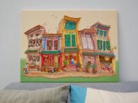 Original Singapore heritage painting Spottiswoode Park Shophouses on a sofa for size reference