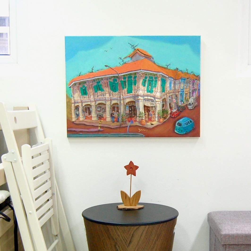 Singapore shophouse painting of Blair Road Corner displayed hung above a small table for size reference